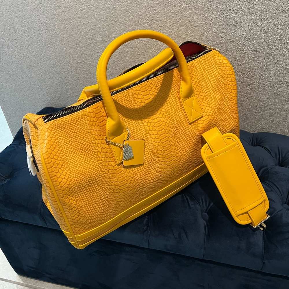 New. Mustard yellow travel weekender with storage bag